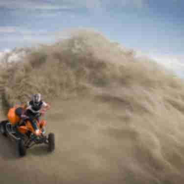 Guy on ATV in sand dunes