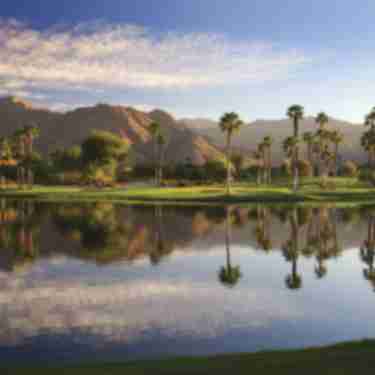 Indian Wells Golf Resort Trees Reflecting On A Pond With Mountains In The Back Ground
