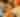 Close up of multiple different types of pumpkins. Yellow, green, and orange pumpkins.