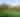 Green golf course against mountains and palm trees
