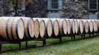 Line of bourbon barrels on a track