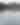 Landscape image of boat in middle of lake turning with someone tubing behind and hills all around