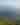 Landscape of green hills and fog