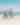 Two women doing yoga on the beach looking at the ocean