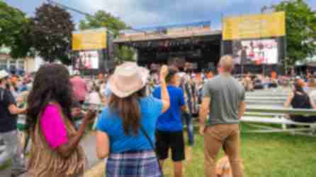 People dance in the audience outside the Chevy Court stage at the Great New York State Fair