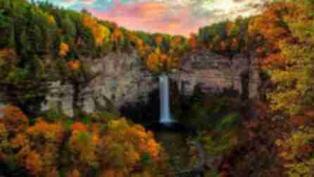 Vibrant fall foliage surrounding a tall waterfall
