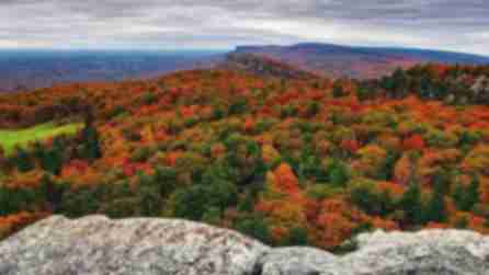 Vibrant fall foliage covering the Shawangunk Mountain range