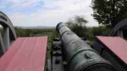 A cannon pointed into a field at the Saratoga National Historical Park