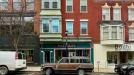 An old station wagon parked in front of an antiques shop in Hudson, NY