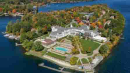 aerial view of the Sagamore Resort surrounded by early fall foliage and the blue waters of Lake George