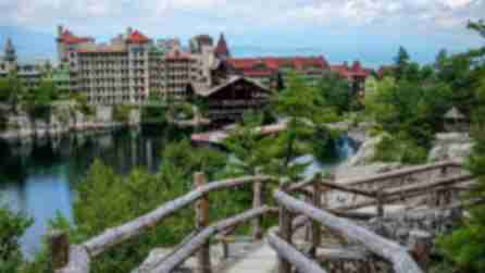View the Victorian castle style-resort Mohonk Mountain House from a wooden bridge in the Hudson Valley, NY
