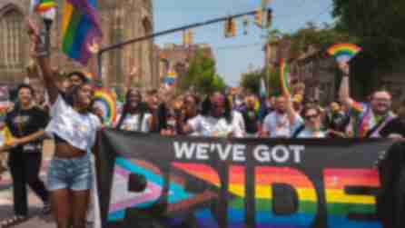 People march in the Capital Pride Parade and Festival holding a sign that reads "We've Got Pride"