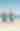 Two women doing yoga on the beach looking at the ocean