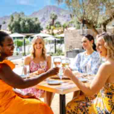 Four women outdoor dining at Citrus & Palm
