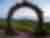 view of a circular sculpture and vineyards at Paloma Vineyards