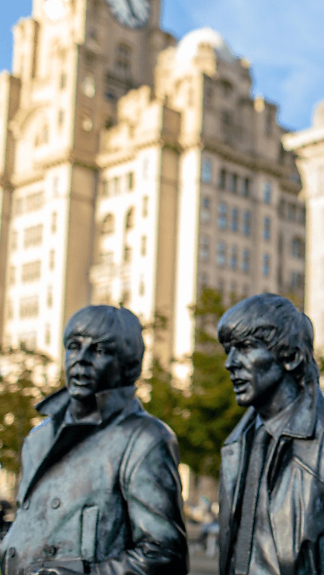 Larger than life statues of The Beatles in front of the Royal Liver Building.