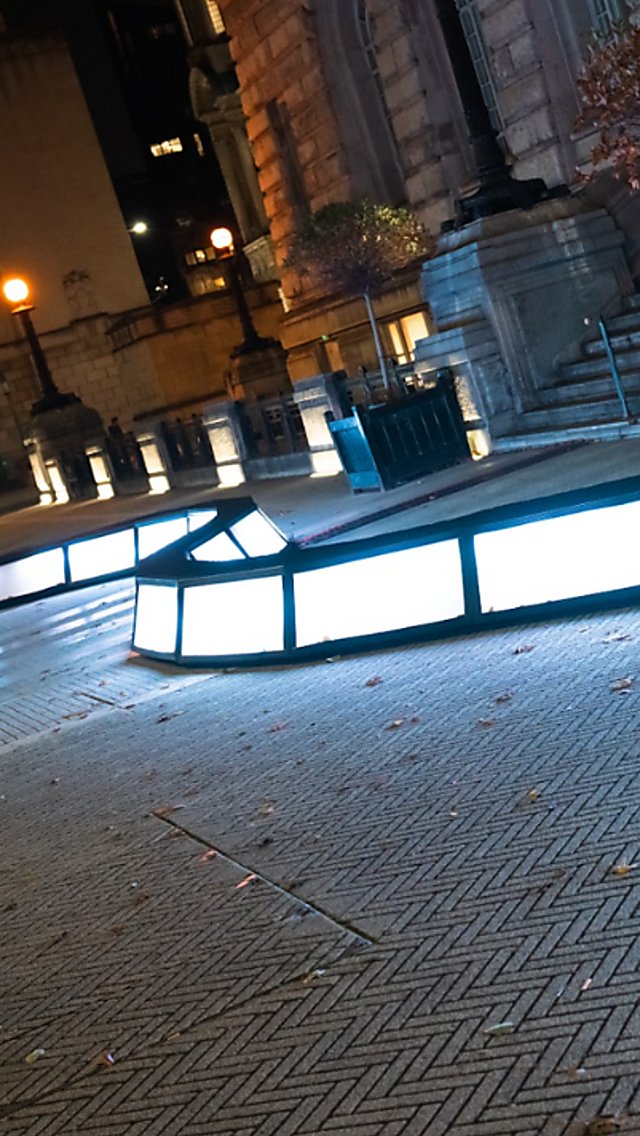 A light installation that is a wave of boxes of light that people can walk across.