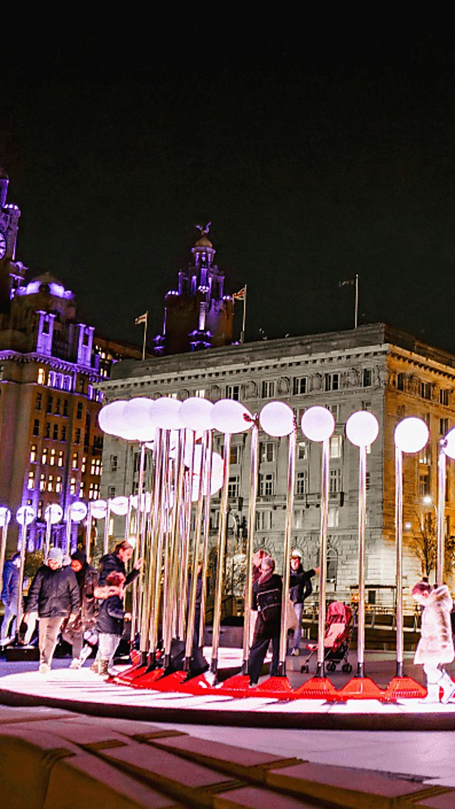 Piano Walk installation outside of the Three Graces with people talking on the piano.
