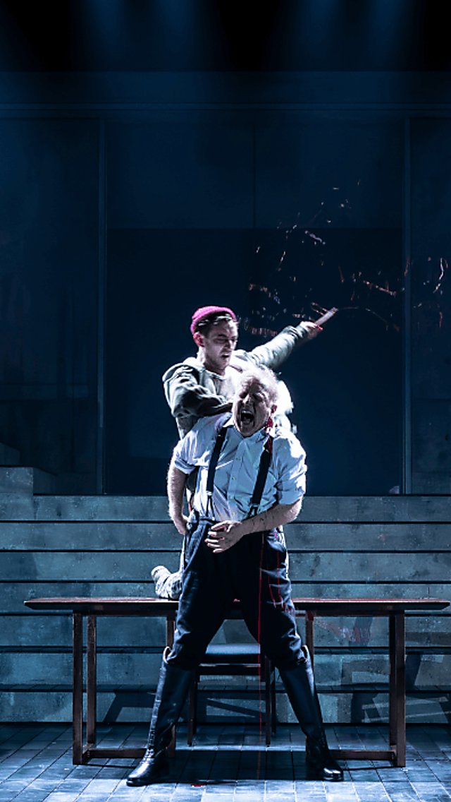 Actors in a modern adaptation of Macbeth