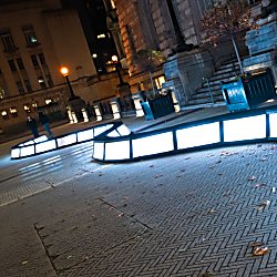 A light installation that is a wave of boxes of light that people can walk across.