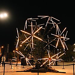 A light installation that takes inspiration from a neuron lit up in orange lights.