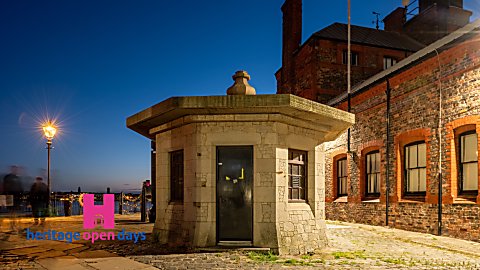 A little brick house on Royal Albert Dock at night