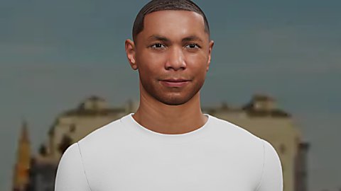 A centered, front-facing portrait of a person wearing a plain white T-shirt with the words “Visit Liverpool” printed in small black text on the upper left chest. The background is softly blurred, showing indistinct buildings and architectural shapes, giving a city setting. The person is framed from the chest up, with even lighting and a neutral backdrop that keeps focus on the face and the shirt’s text.