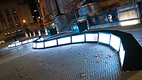 A light installation that is a wave of boxes of light that people can walk across.