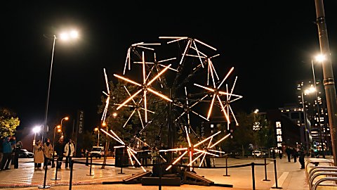 A light installation that takes inspiration from a neuron lit up in orange lights.