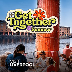People sat outdoors on the Royal Albert Docks in the summer. "Get Together This Summer"