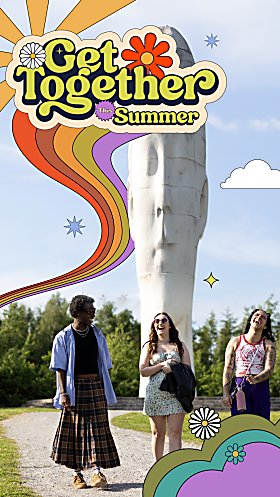 Three people walking and laughing with The Dream head in the background.