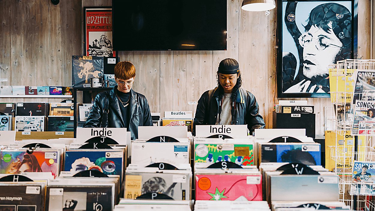 Two people stood looking at records in the record store.