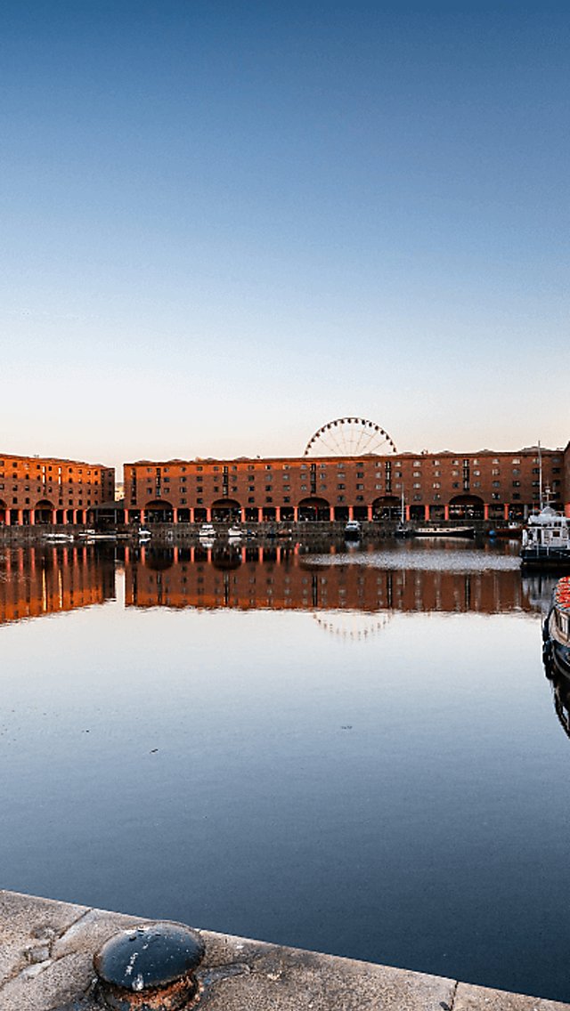 The Royal Albert Dock at dusk with the sky reflecting in the dock.