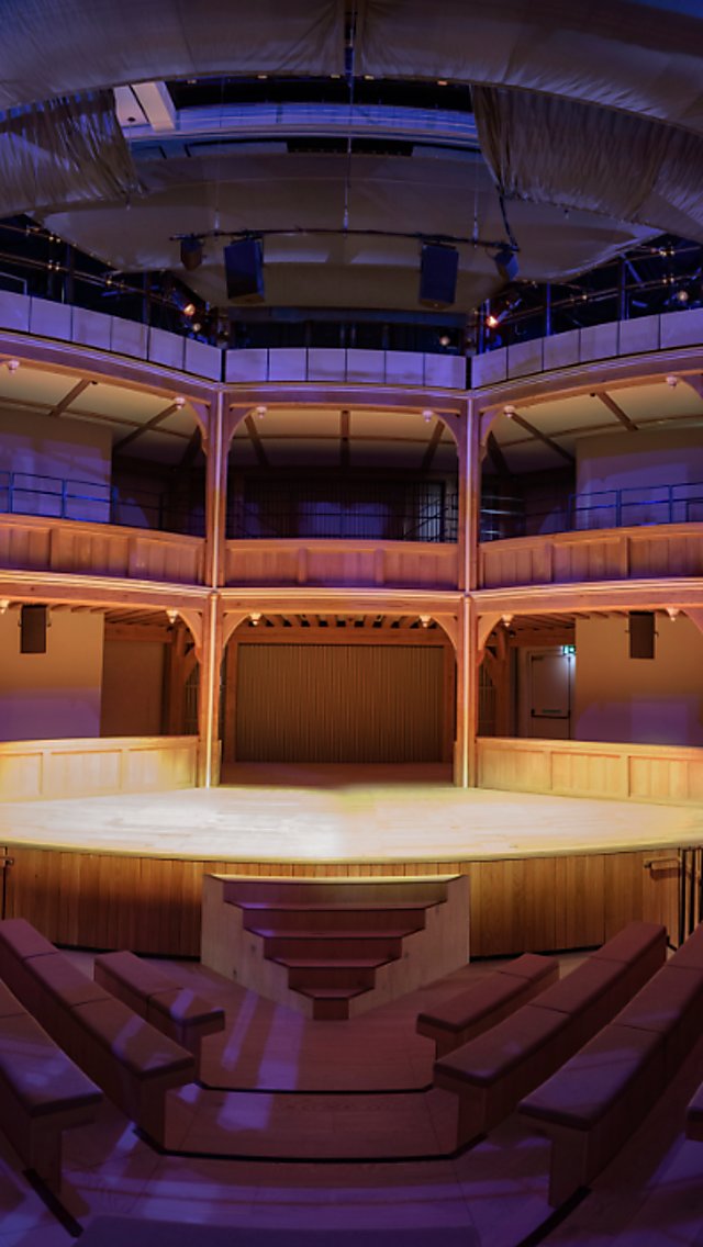 The inside of Shakespeare North Playhouse, with the stage lit up and the seats dimmed in a purple hue.