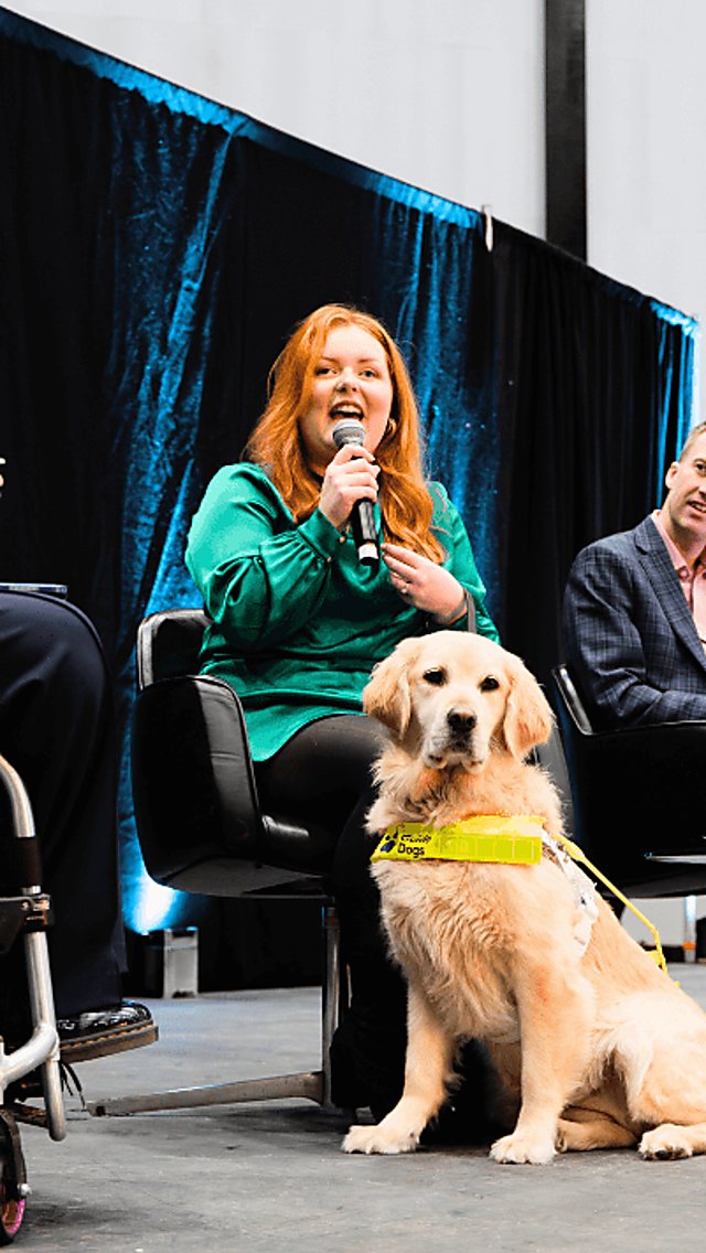 panellists sit on a stage at the accessibility forum