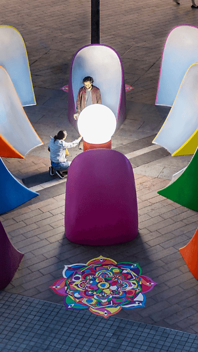Rangoli Mirrored Cosmos in a circular fashion is surrounding a ball which is lit up.