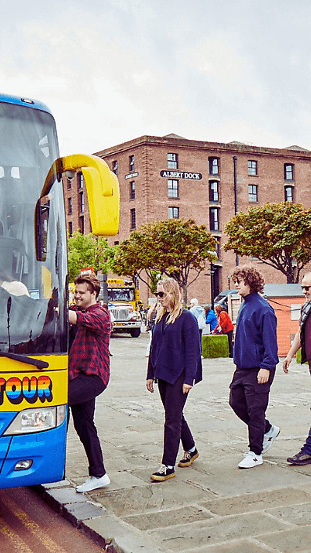People getting onto the Magical Mystery Tour bus at the Royal Albert Dock