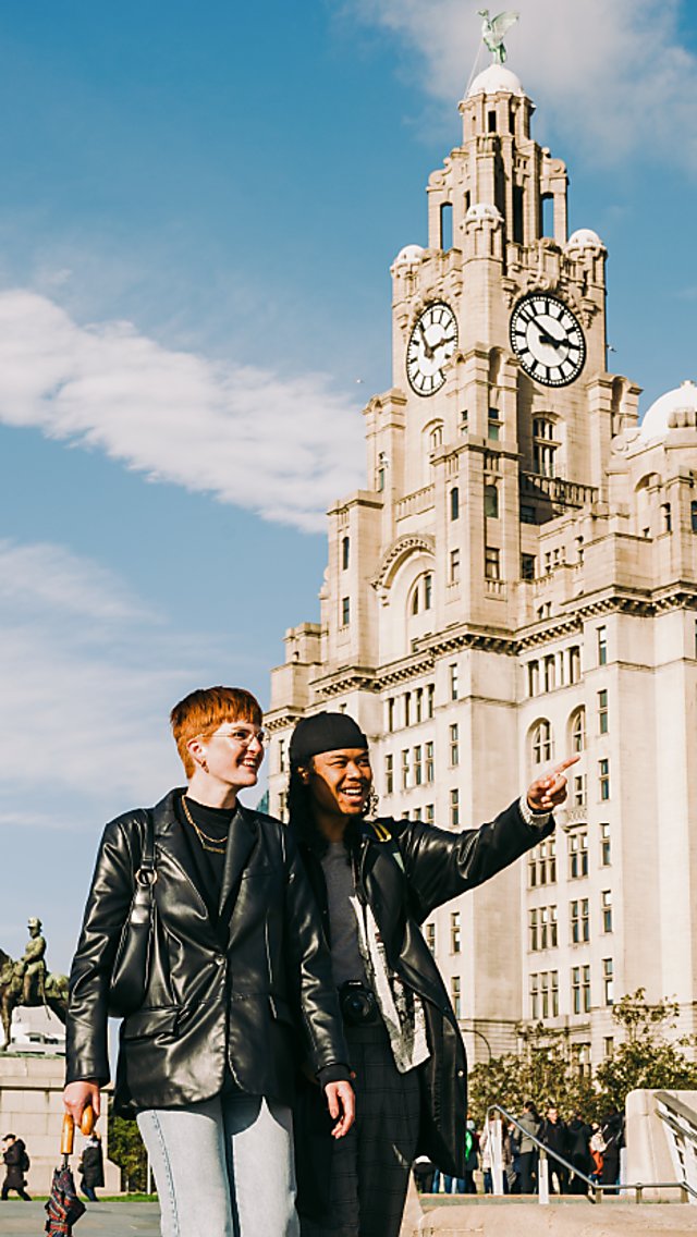 Two people walking on the Pier head in leather jackets