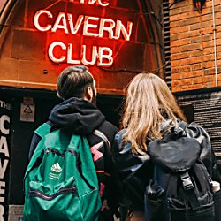 Two people stand outside the Cavern Club