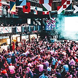 Crowds of people watching football at BoxPArk