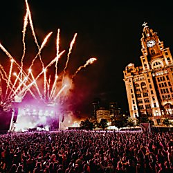 Fireworks exploding in the sky by the Liver Building and behind the stage at On The Waterfront 2025