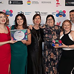 People standing holding an award at the LCR Tourism Awards