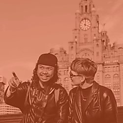 Two people looking towards the Mersey with a Liver bird in the background.