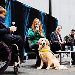panellists sit on a stage at the accessibility forum