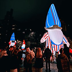 No Place Like Gnome installation with a crowd of people around the base of the artwork.
