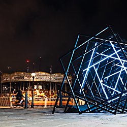 An art installation made of diffrent squares in a line lit up blue.