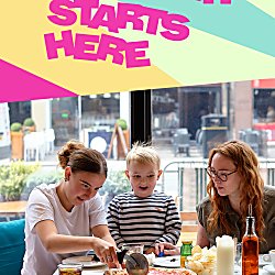 Three people sitting at a table, one adult a teenager and a small child eating pizza. The text says 'Summer Starts Here' in pink text.