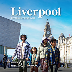 A family of four walking towards the Royal Albert Dock while looking out towards Liverpool.