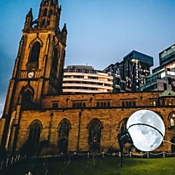 An old church building with a moon being 'lassoed' outside