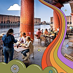 People sitting at tables along the Royal Albert Dock, with red pillars behind them.
